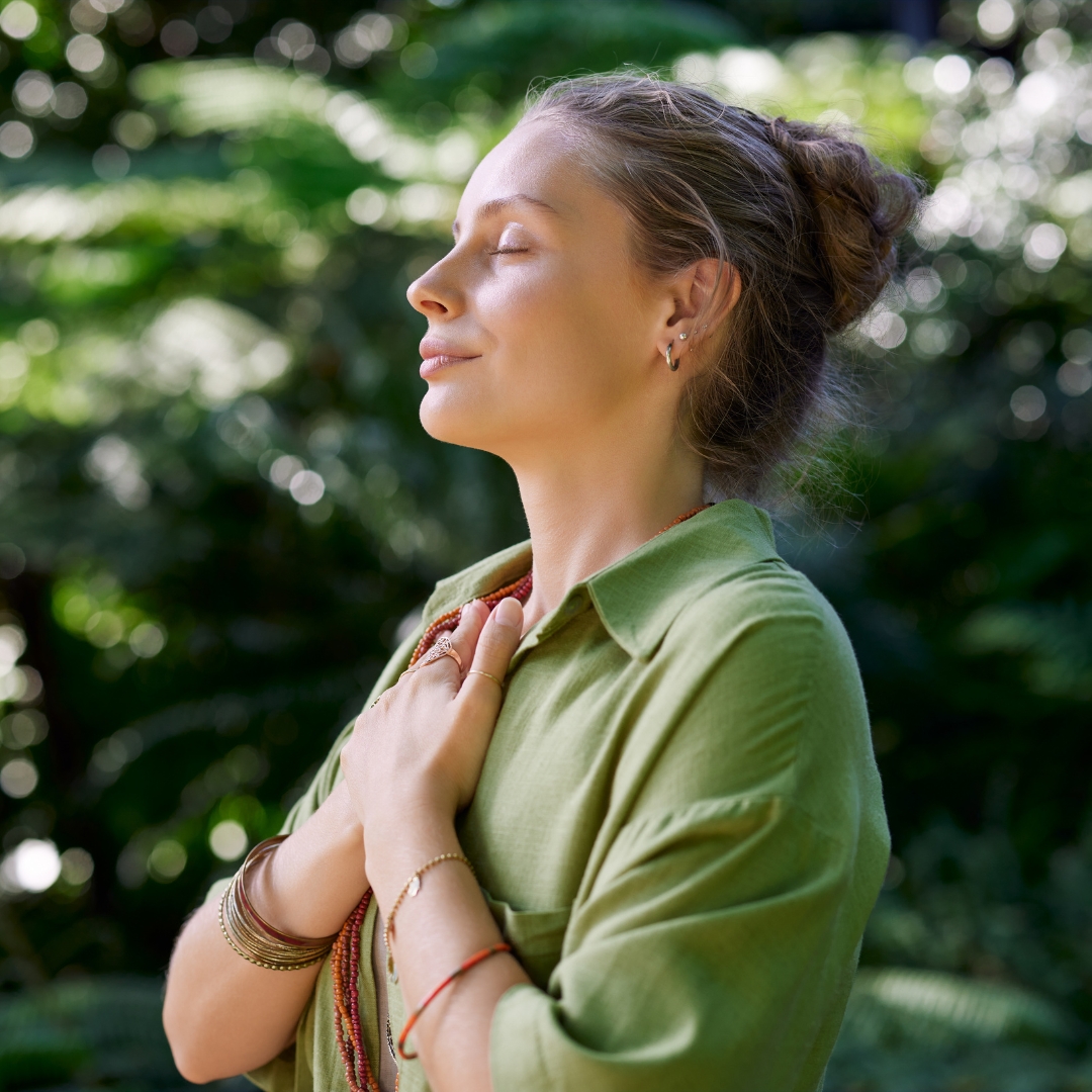 How to overcome envy Christian encouragement from Proverbs 14:30, shown by a woman peacefully praying outdoors.