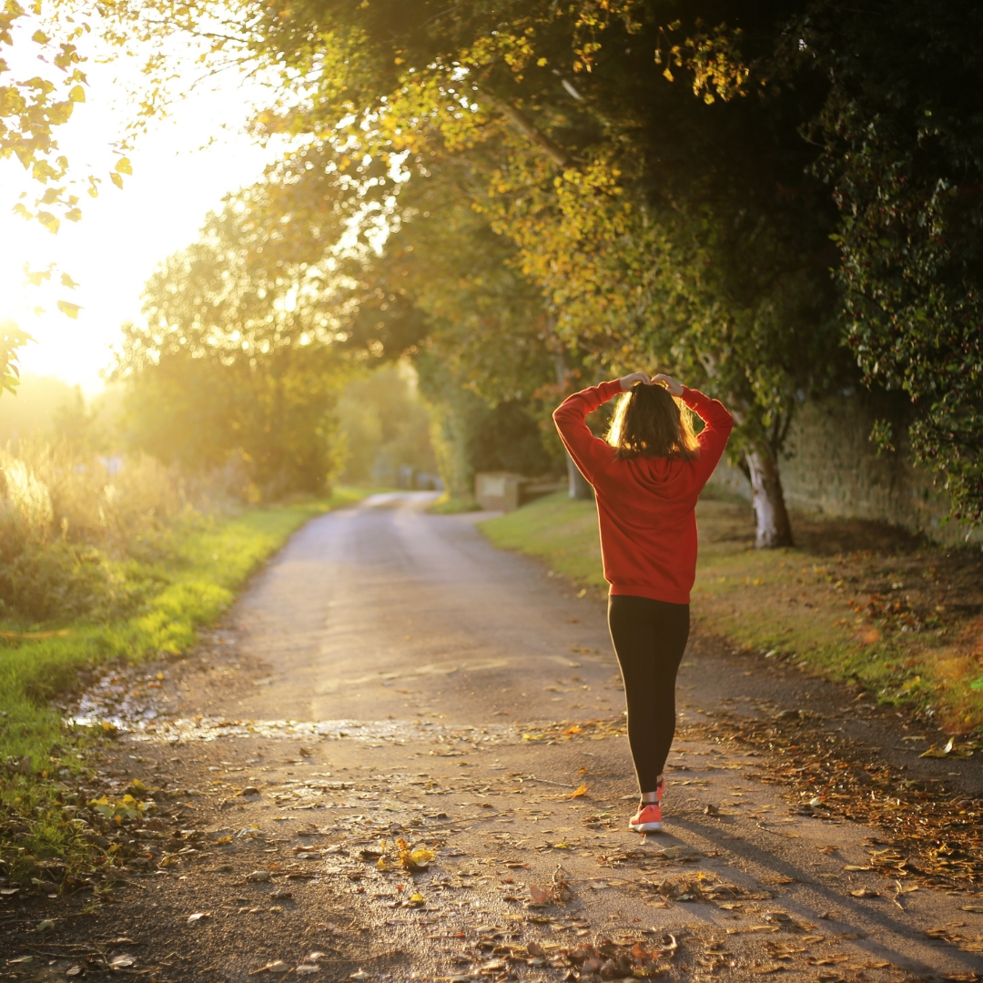 Woman walking along a sunlit path illustrating living in freedom from Galatians 5:1.